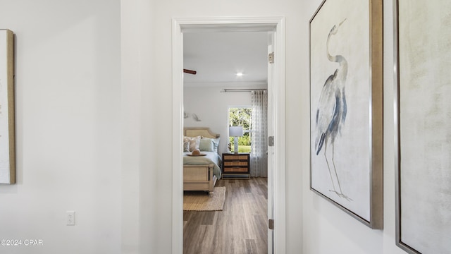 hall with crown molding and hardwood / wood-style flooring