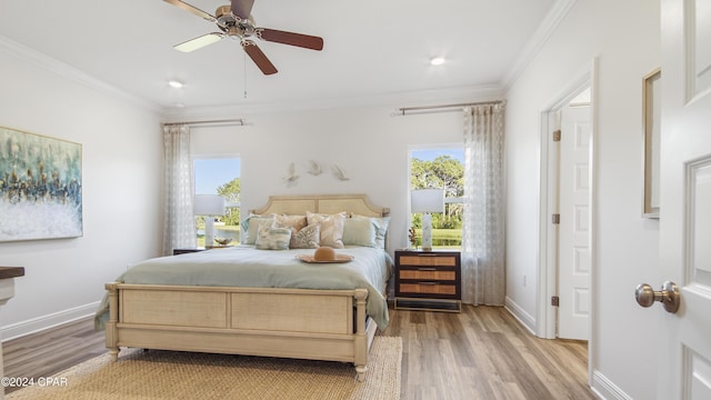 bedroom featuring ceiling fan, crown molding, and light wood-type flooring