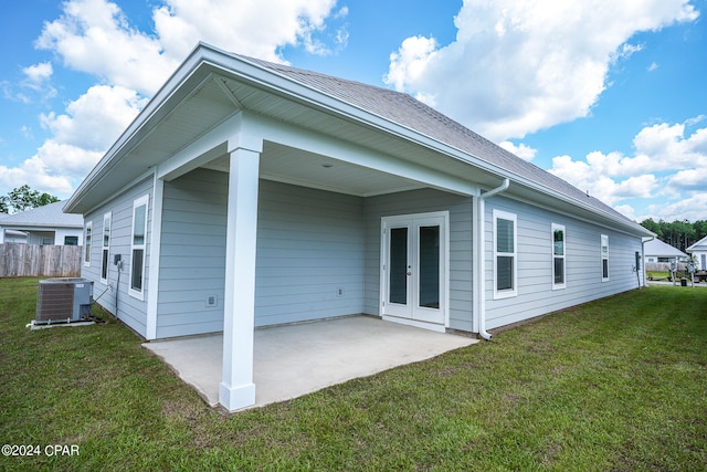 back of house featuring central AC unit, a yard, a patio, and french doors