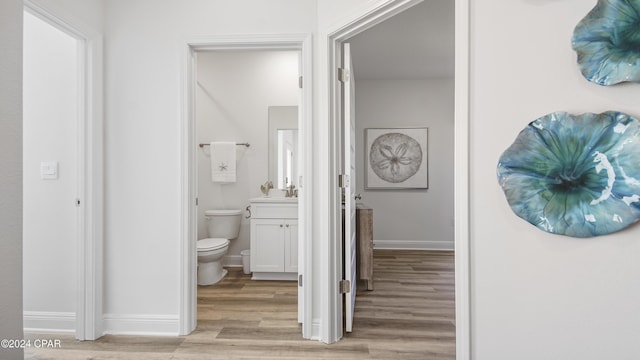 bathroom featuring hardwood / wood-style flooring, vanity, and toilet