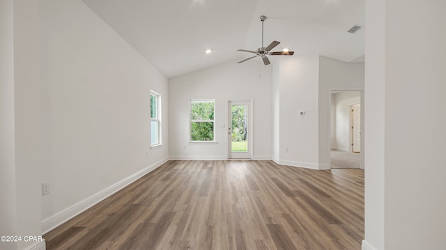 unfurnished living room with high vaulted ceiling, dark hardwood / wood-style flooring, and ceiling fan