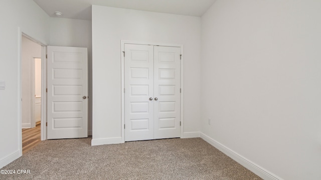 unfurnished bedroom with a closet and carpet