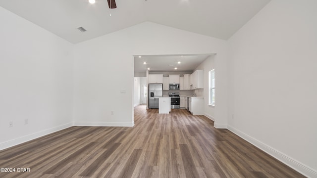 unfurnished living room with ceiling fan, dark hardwood / wood-style floors, and vaulted ceiling