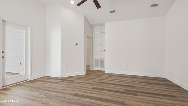 unfurnished room with lofted ceiling, hardwood / wood-style floors, and ceiling fan