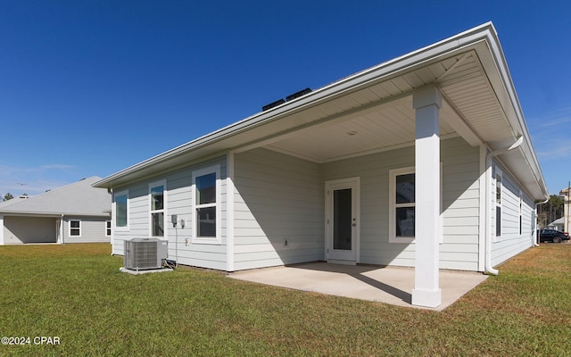 back of house featuring central air condition unit, a yard, and a patio area