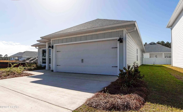 garage featuring a lawn