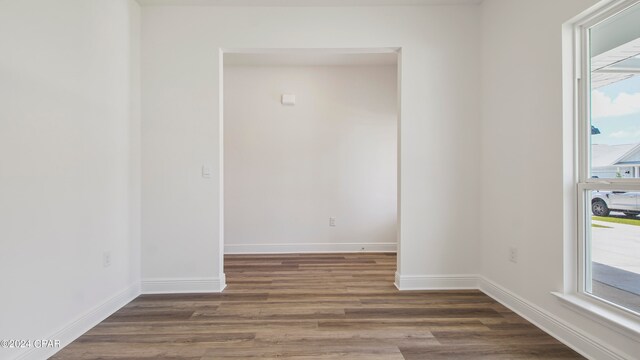 unfurnished room featuring dark wood-type flooring