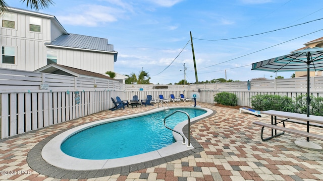 view of pool featuring a fenced backyard, a fenced in pool, and a patio