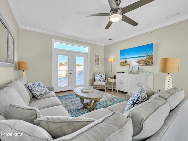 living area featuring ceiling fan, wood finished floors, visible vents, french doors, and ornamental molding