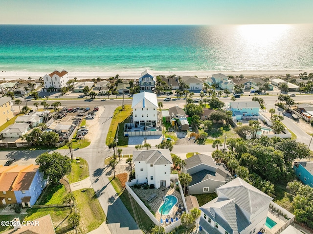 drone / aerial view with a water view, a residential view, and a beach view