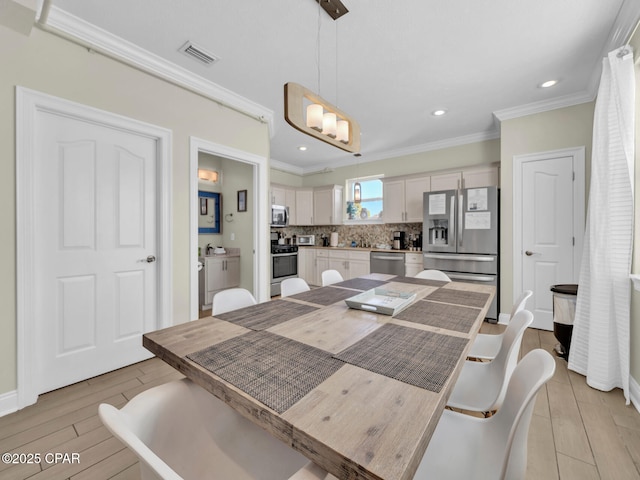 dining room featuring visible vents, baseboards, ornamental molding, wood tiled floor, and recessed lighting