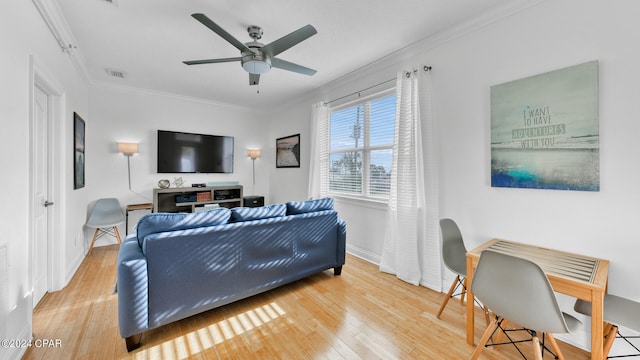 living room with ceiling fan, hardwood / wood-style floors, and crown molding