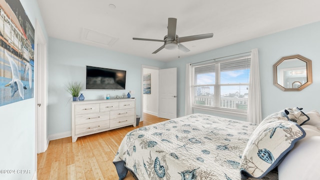 bedroom with light hardwood / wood-style floors and ceiling fan