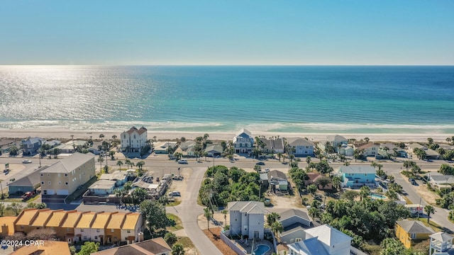 drone / aerial view featuring a beach view and a water view