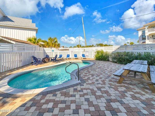 view of swimming pool featuring a fenced backyard, a fenced in pool, and a patio