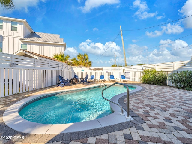 view of swimming pool featuring a fenced in pool, a fenced backyard, and a patio