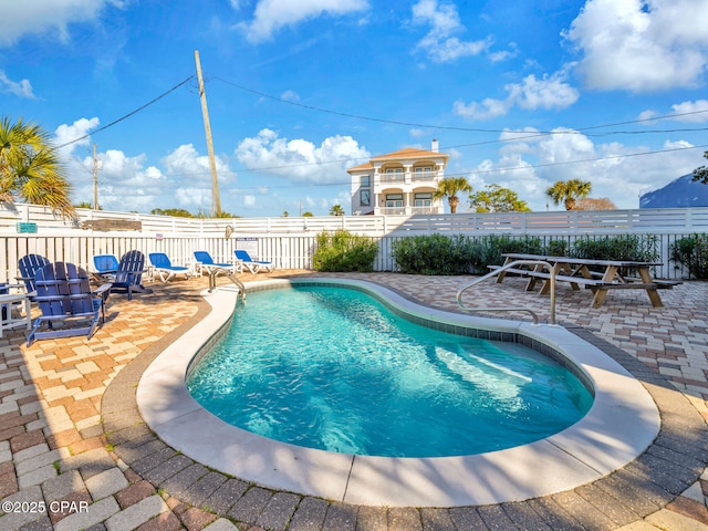 view of swimming pool featuring a fenced in pool, a patio area, and fence