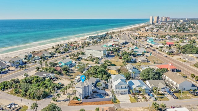 birds eye view of property featuring a view of the beach and a water view