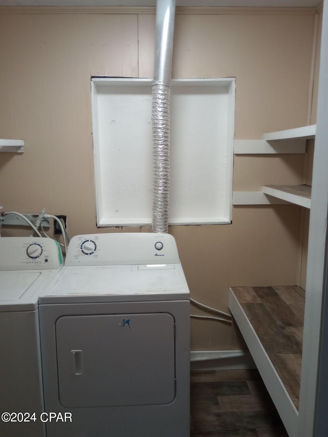 laundry area with dark hardwood / wood-style floors and washer and clothes dryer