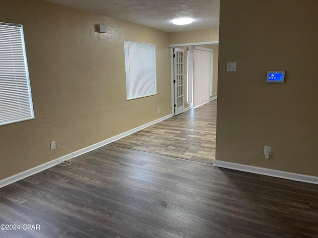 empty room featuring dark wood-type flooring