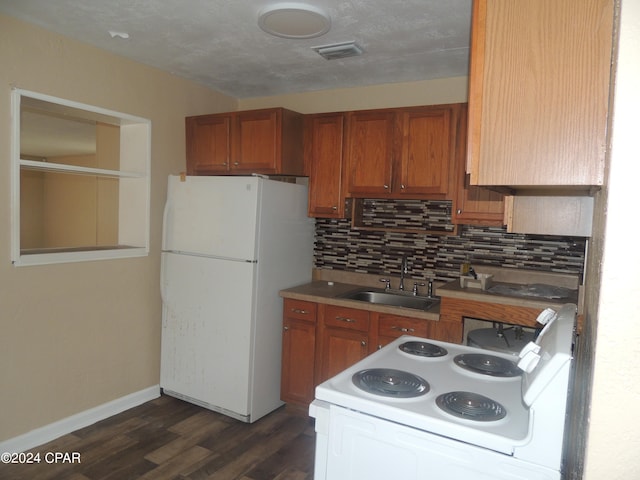 kitchen with sink, dark hardwood / wood-style floors, white appliances, and decorative backsplash