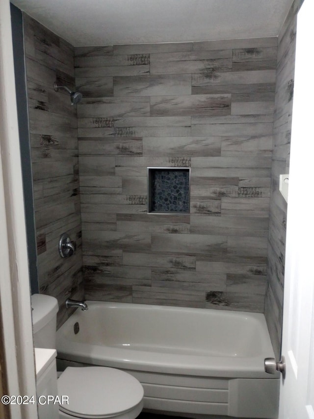 full bathroom with vanity, toilet, and tiled shower / bath