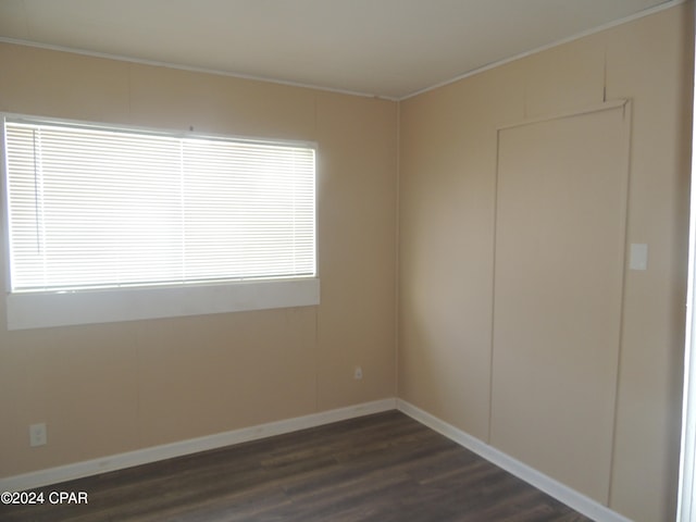 empty room with dark hardwood / wood-style flooring