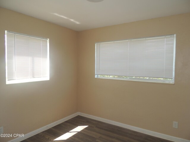 spare room featuring dark hardwood / wood-style floors