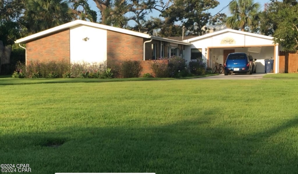 single story home with a front yard and a carport