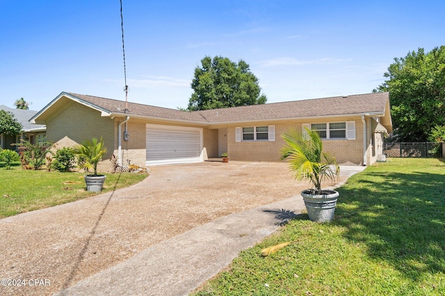 single story home featuring a garage and a front lawn