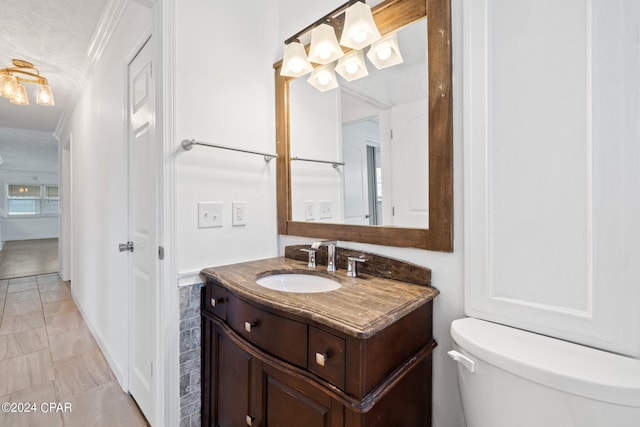 bathroom featuring vanity, crown molding, tile patterned floors, a textured ceiling, and toilet