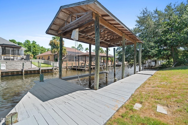 view of dock featuring a yard and a water view