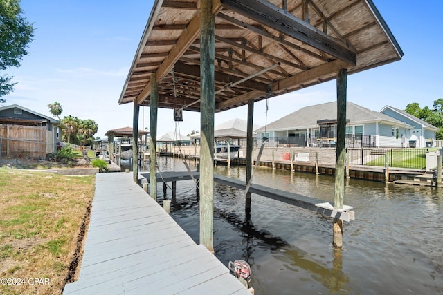 view of dock featuring a yard and a water view