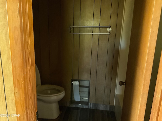 bathroom featuring toilet and a tub to relax in