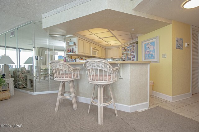 laundry room with light tile patterned floors and stacked washer and clothes dryer