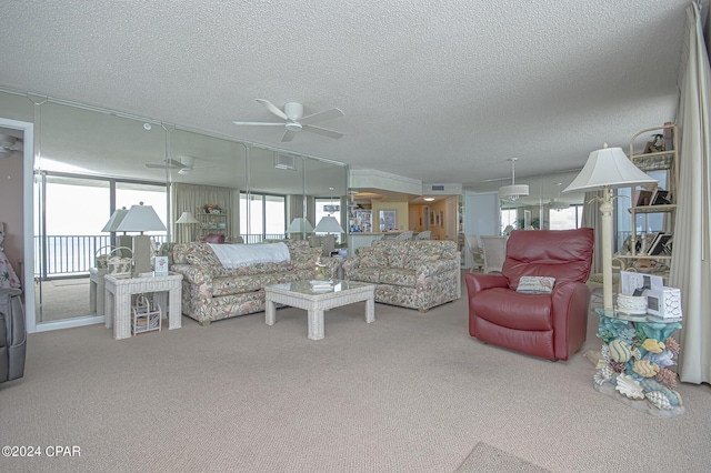 living room with a textured ceiling, ceiling fan, and carpet