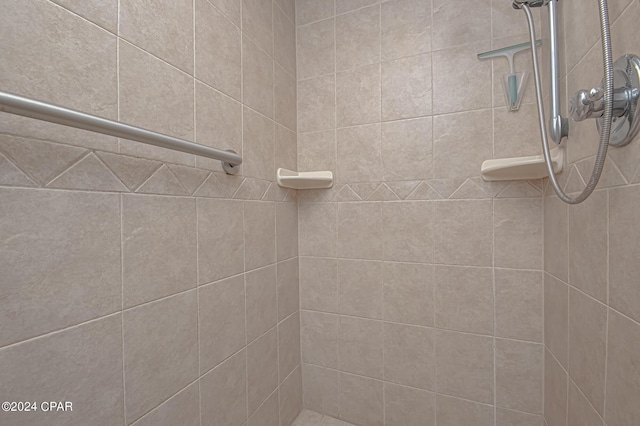 bathroom with a tile shower