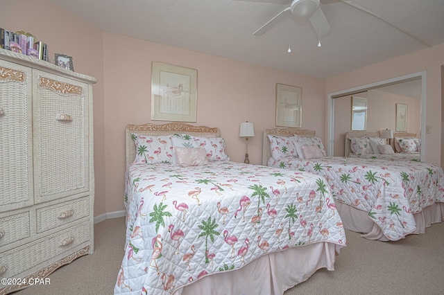 bedroom with a closet, ceiling fan, and carpet flooring