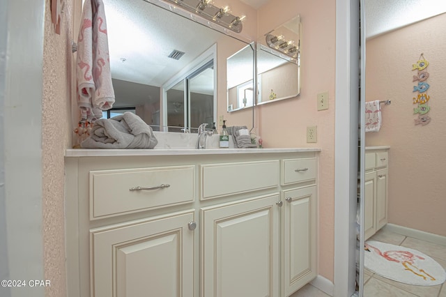 bathroom with vanity and tile patterned floors