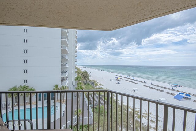 balcony featuring a water view and a view of the beach