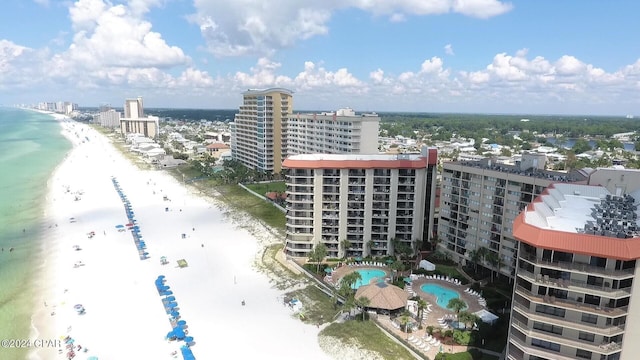 bird's eye view featuring a water view and a beach view