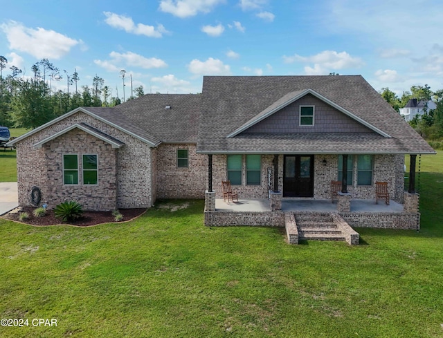 rear view of house with a yard and a patio area