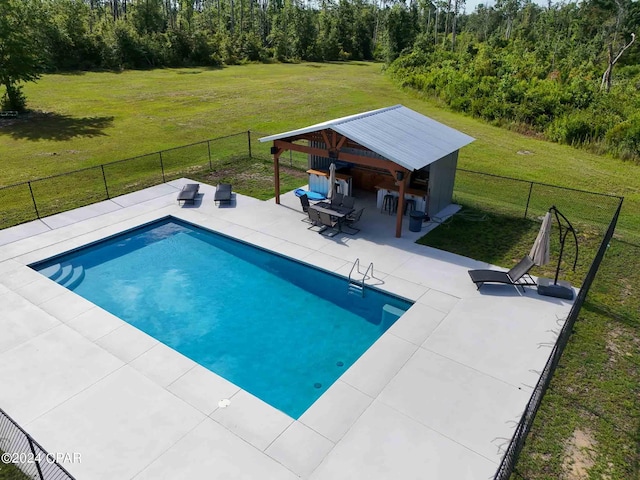 view of pool with a lawn, a patio area, and a gazebo