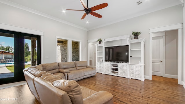 living room with ceiling fan, hardwood / wood-style flooring, and ornamental molding