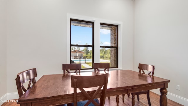 dining space with hardwood / wood-style floors