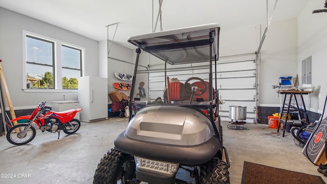 garage with electric panel and white fridge