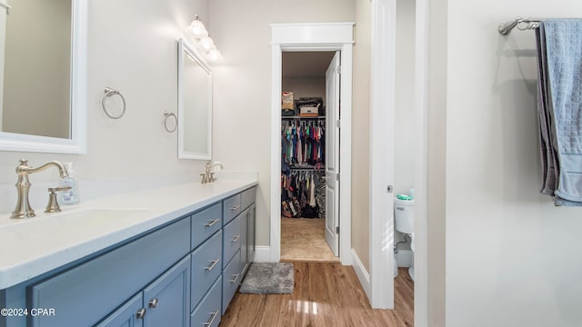 bathroom featuring vanity, hardwood / wood-style floors, and toilet