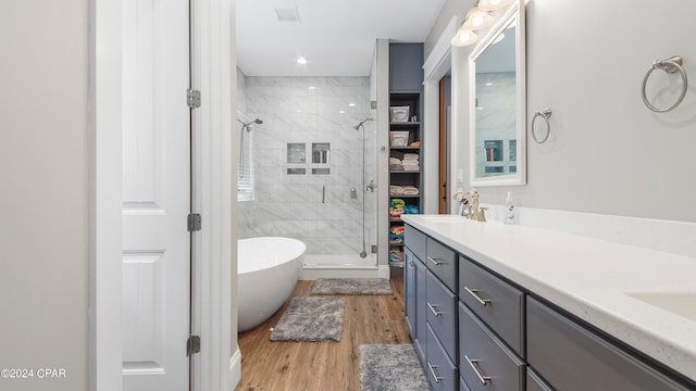 bathroom featuring vanity, shower with separate bathtub, and wood-type flooring