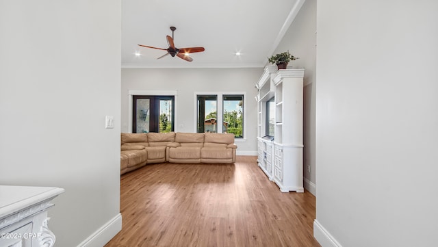 living room featuring light wood-type flooring, ornamental molding, and ceiling fan