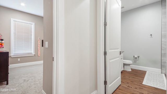 bathroom featuring hardwood / wood-style floors and toilet